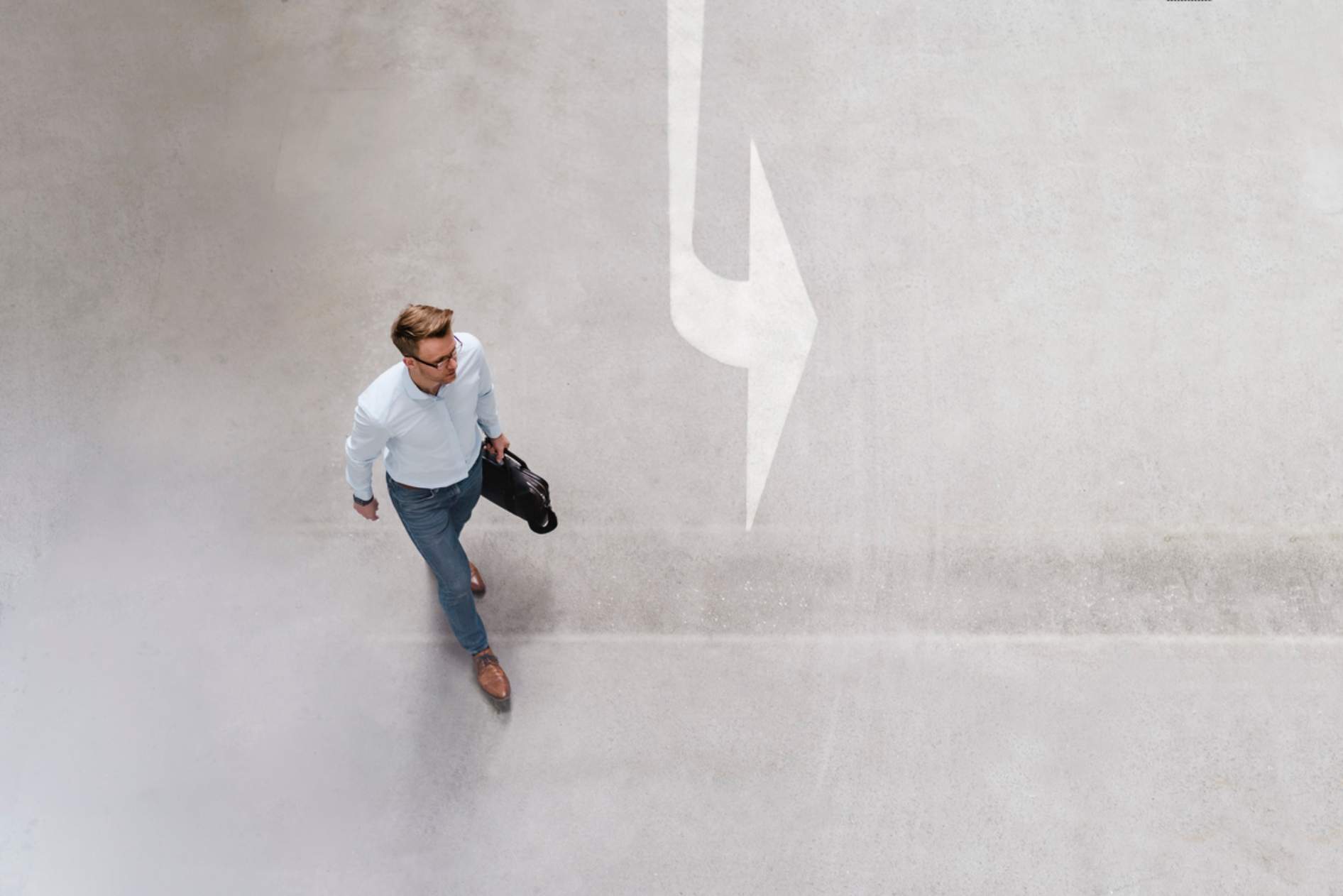 Man walking in direction of an arrow