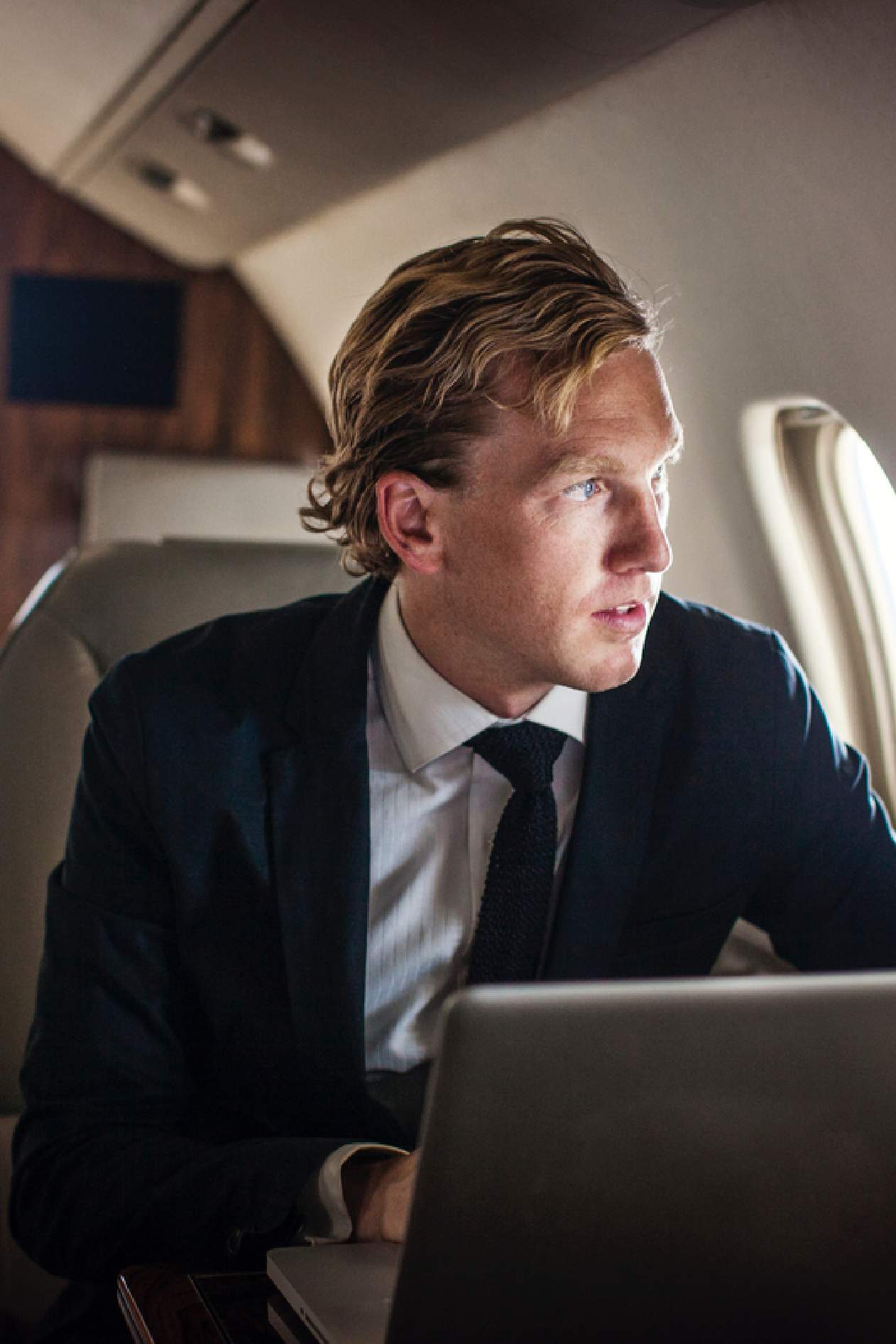 Man looking out airplane window