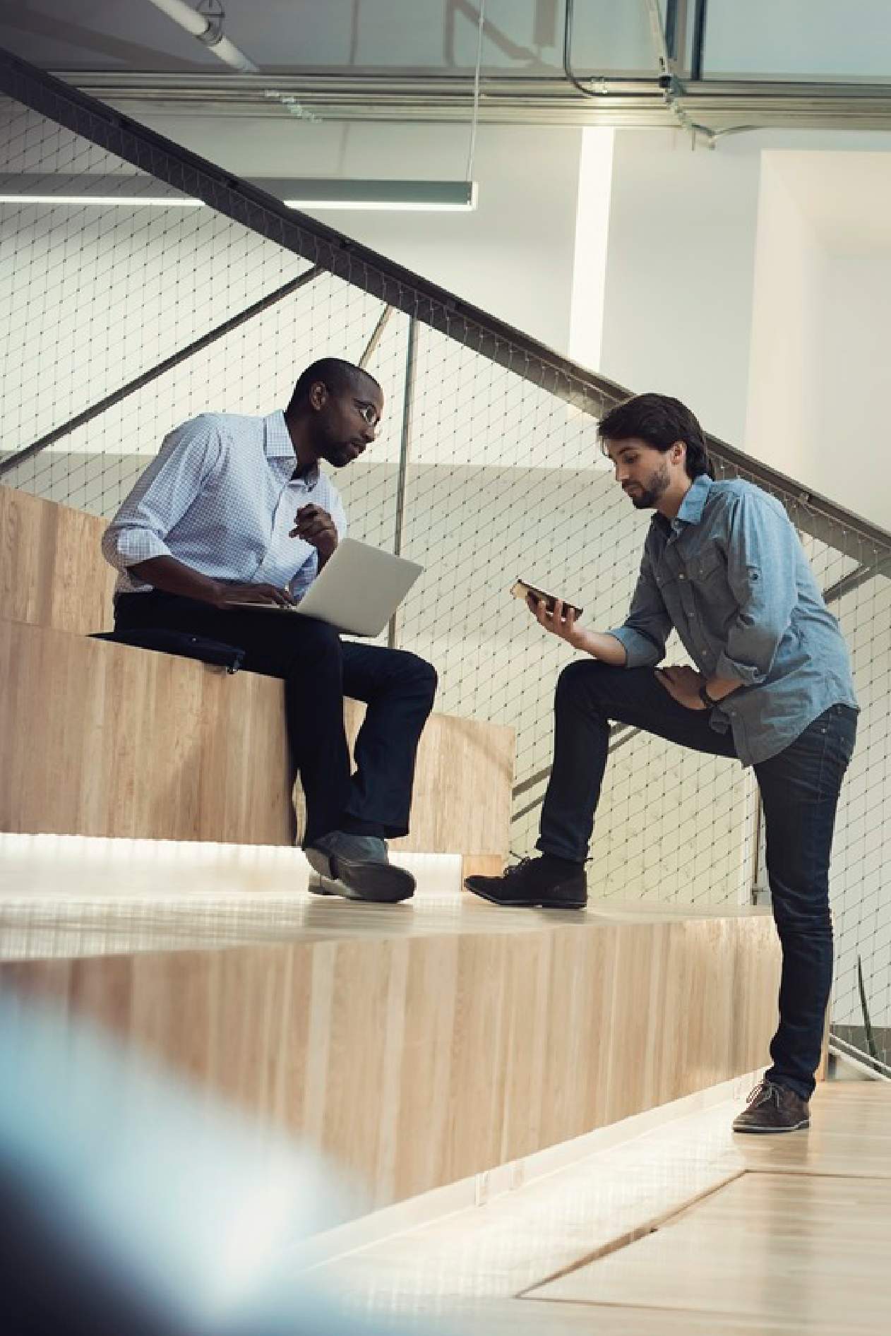 Two analysts talking in office